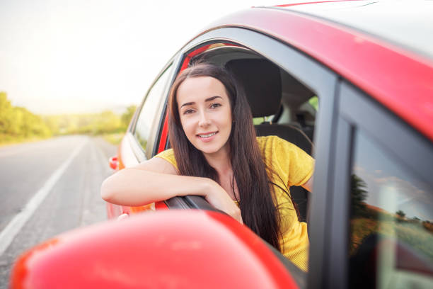 istock Happy beautiful woman is driving a car. 1321016421