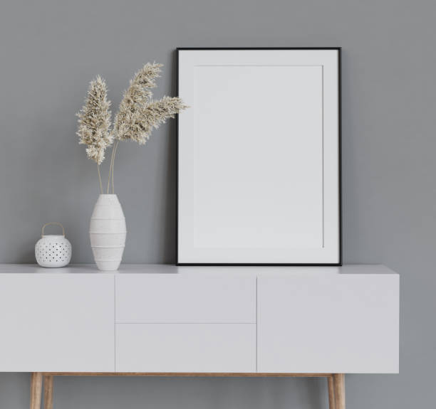 istock Mock up poster frame on white cabinet in simple home interior. 3d render. 1321016522