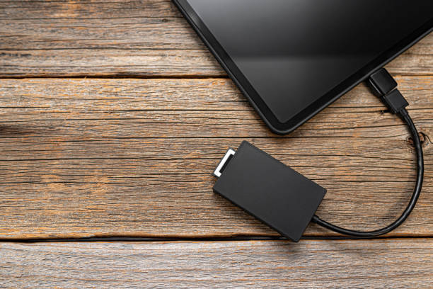 istock Memory card or external hard drive is connected to the Tablet PC. 1321017163