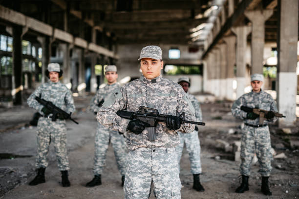 istock Soldier and his squad team portrait in urban environment 1321017193