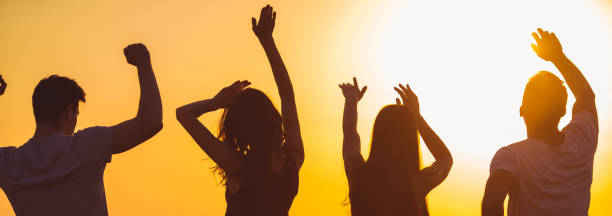 istock The four people dancing on the sunset background 1321017330