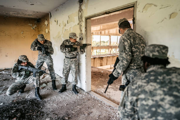 istock Military assault team stalking through corridor in abandoned building 1321017510