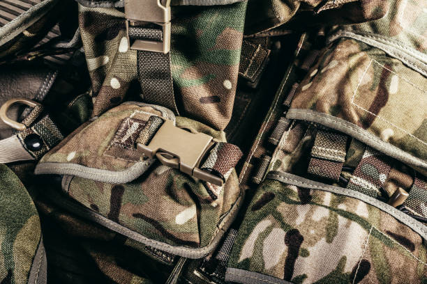 istock Multi camouflaged soldier vest pouch row system. 1321017515