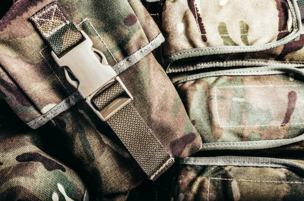 istock Camouflaged soldier vest pouches with lock catch. 1321017517