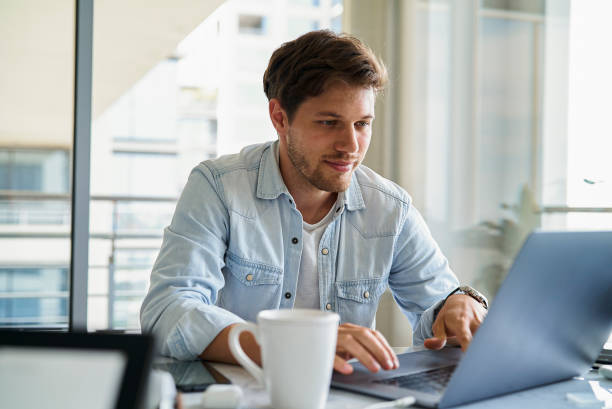 istock Portrait of design editor working on laptop while having a breakfast in the morning 1321017537