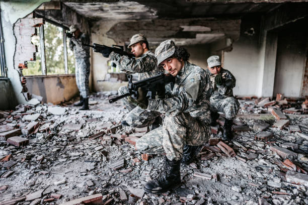 istock Military assault team stalking through corridor in abandoned building 1321017548