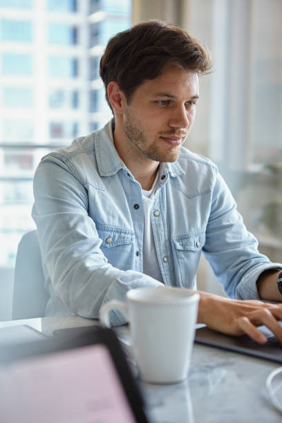 istock Portrait of design editor working on laptop while having a breakfast in the morning 1321017550
