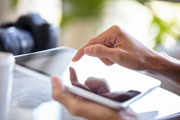 istock Close up of young adult woman´s hand using touchscreen device during daytime 1321017685