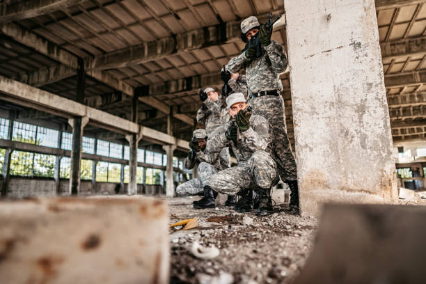 istock Military assault team taking cover in abandoned building 1321017686