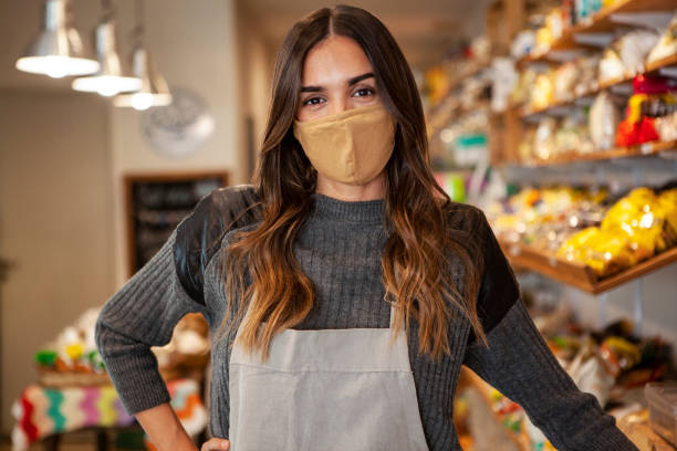 istock Portrait of young entrepreneur wearing protective face mask while standing inside organic market 1321017730