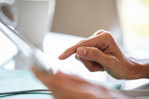 istock Close up of young adult woman´s hand using touchscreen device during daytime 1321017735