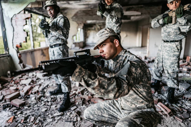 istock Military assault team stalking through corridor in abandoned building 1321017760