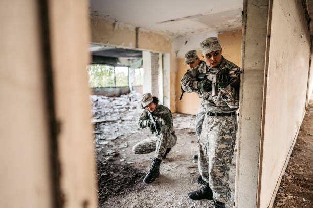 istock Military assault team stalking through corridor in abandoned building 1321018006