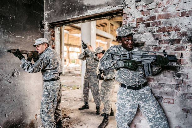 istock Military assault team stalking through corridor in abandoned building 1321018044
