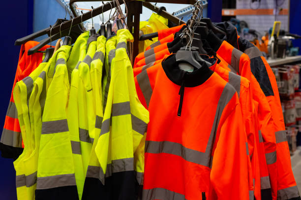 istock Worker signal jackets hanging on rack on construction supply store. 1321018116