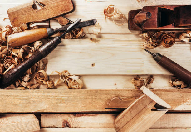 istock Old fashioned planes with carving chisels laying on workbench 1321018143