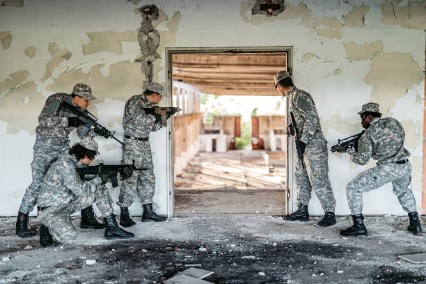 istock Military assault team stalking through corridor in abandoned building 1321018155
