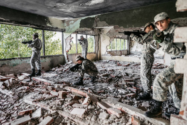 istock Military assault team stalking through corridor in abandoned building 1321018726
