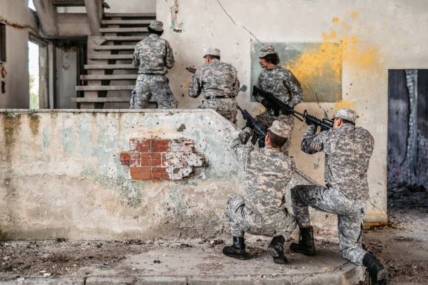 istock Military assault team stalking on staircase in abandoned building 1321018843