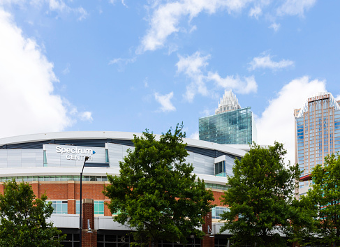 Charlotte, NC, USA-30 May 2021: Spectrum Center indoor basketball arena with skyscrapers behind.