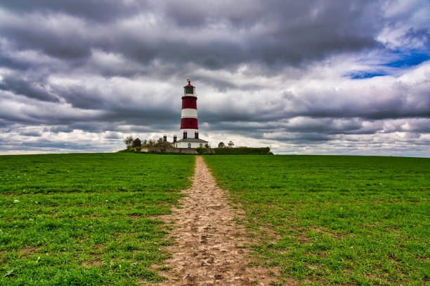 istock Happisburgh lighthouse against dramatic sky, Happisburgh, Norfolk, England, Britain 1321020123