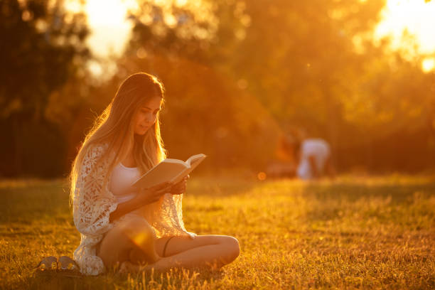 istock young woman studying on the grass at sunset 1321020166