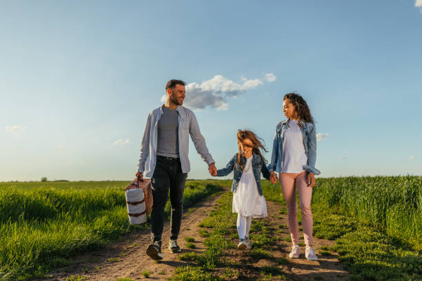 istock Happy family walking in the fields 1321021136