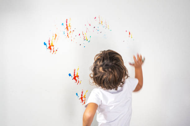 istock Boy Showing Colorful Paint on His Hands 1321022703
