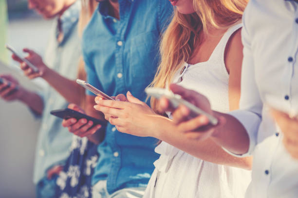 istock Group of young people using mobile phones 1321023731