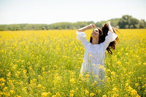 istock Young woman in the rapeseed field 1321024782