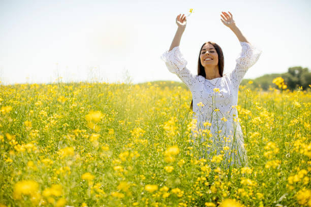 istock Young woman in the rapeseed field 1321024790