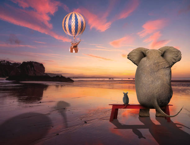 istock Elephant and ouse friends sitting together 1321025812