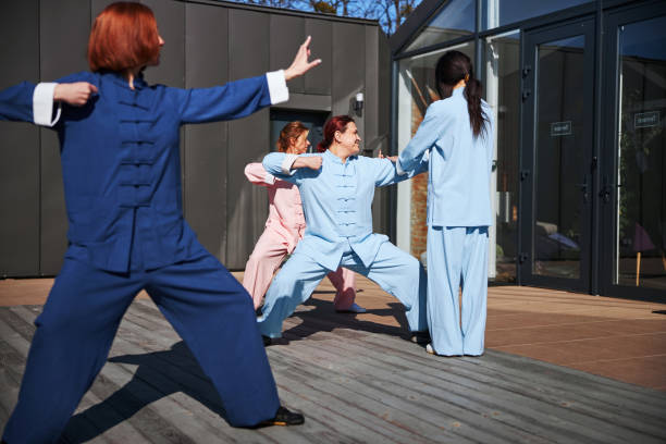 istock Group of women working out with tai chi 1321026122