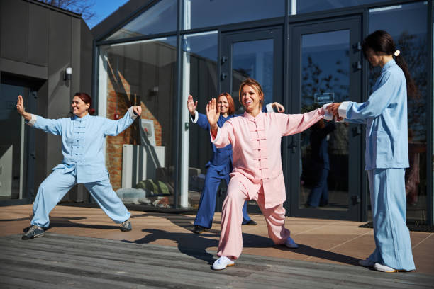 istock Mirthful young women practicing qigong on the terrace 1321026173