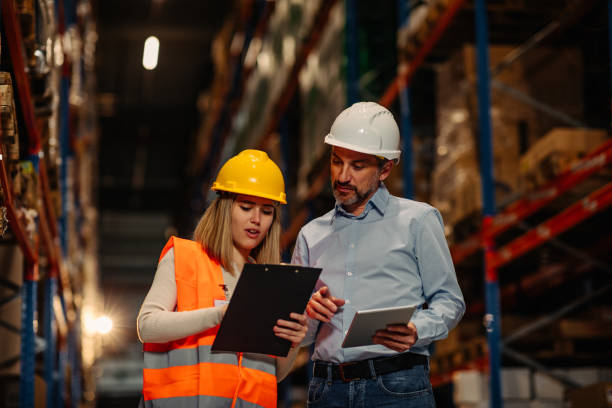 istock Businesspeople discussing about work in warehouse 1321028099