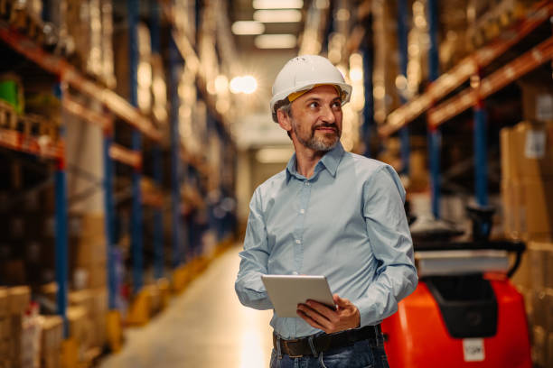 istock Young businessman in factory using tablet 1321028100