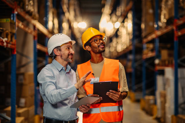 istock Businesspeople discussing about work in warehouse 1321028104