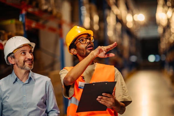 istock Businesspeople discussing about work in warehouse 1321028105