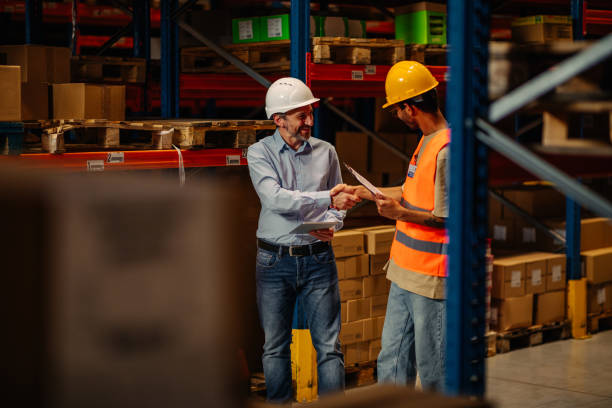 istock Supervisor and male worker at meeting in warehouse 1321028117