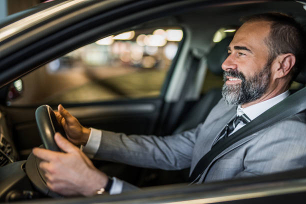 istock Businessman driving a car. 1321029038