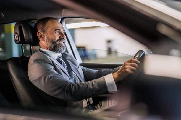 istock Businessman driving a car. 1321029048