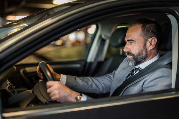 istock Businessman driving a car. 1321029053