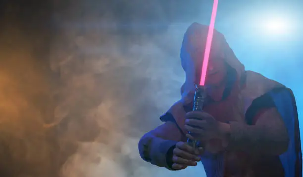 a man holds a laser lightsaber in his hands render 3d