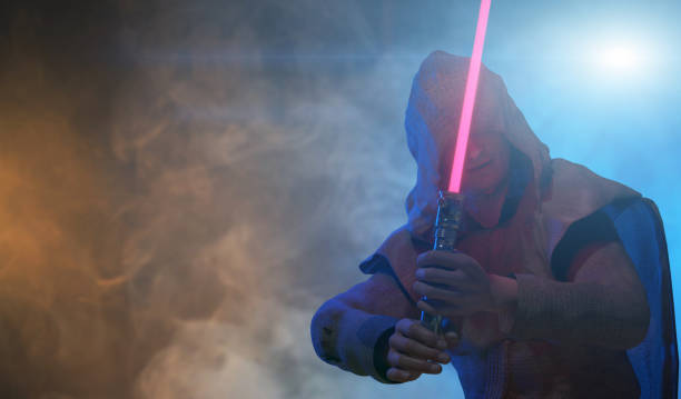 a man holds a laser lightsaber in his hands render 3d - cosplay imagens e fotografias de stock