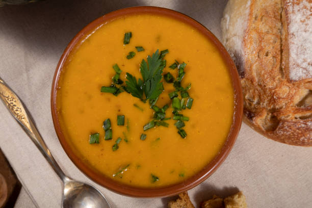 istock Pumpkin broth on wooden background 1321034311