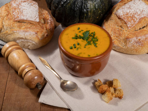 Pumpkin broth on wooden background Pumpkin broth on wooden background. kabocha stock pictures, royalty-free photos & images