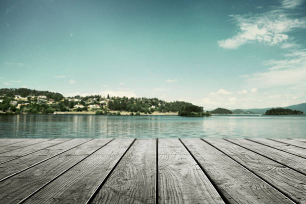 istock Empty wooden table for product and blurred fresh landscape nature background. 1321034399