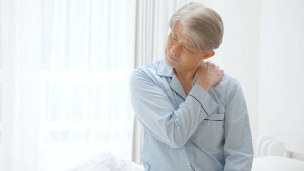 istock middle aged asian man having stiff shoulder in the bed room 1321038340