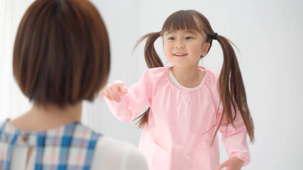 istock young asian girl playing with childminder 1321038418