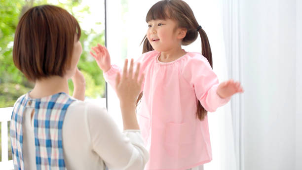 istock young asian girl playing with childminder 1321038419